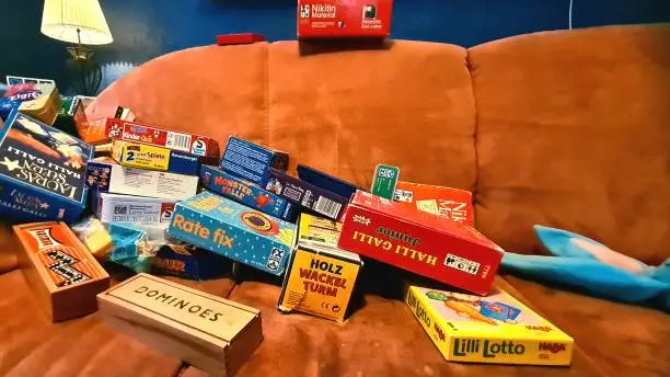 Games collection, terracotta sofa in front of blue wall.