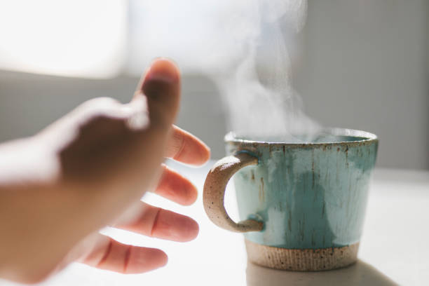 istock Hands of man touching coffee cup gently 1355235104