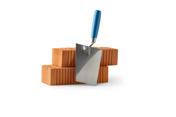 Trowel and Red ceramic brick. Tool and Material for building. Isolated on white background.