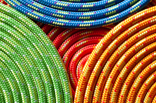 Coiled yellow, red, green and blue rope.