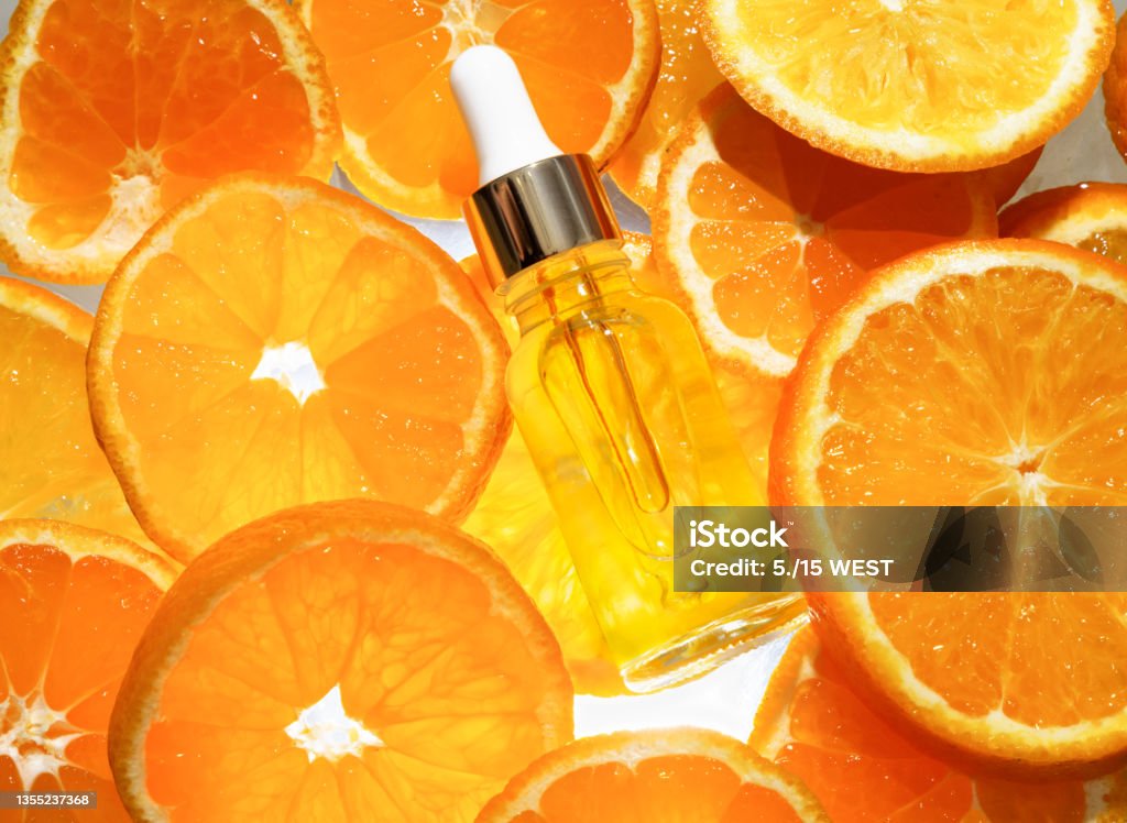 Facial serum in a glass bottle with vitamin C. A cosmetic product with a natural ingredient for all ages. Top view Vitamin C Stock Photo