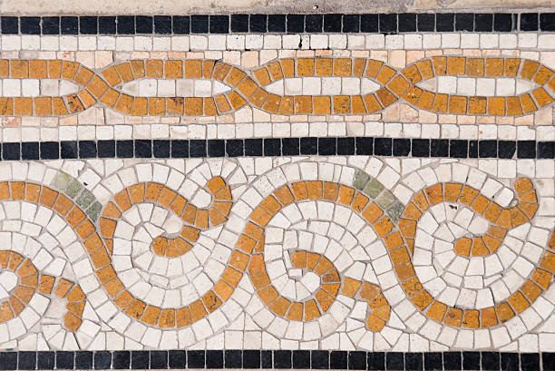 Ancient Italian Roman mosaic floor with geometric shapes composed of small colored stone tiles