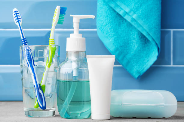 istock The toothbrushes in a glass in blue bathroom. 1355237783