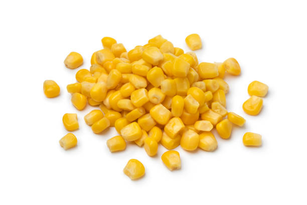 istock Heap of yellow cooked sweet corn kernels on white background 1355239430
