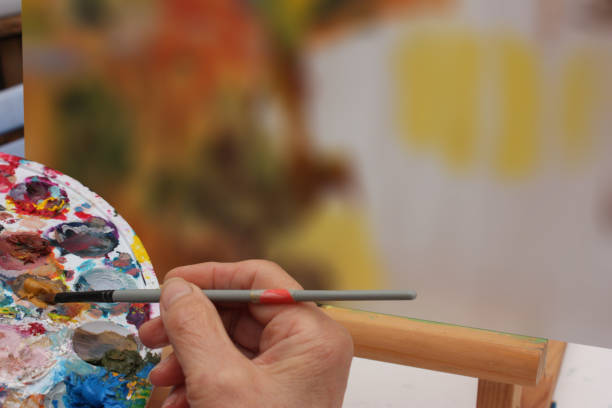 istock Painter painting a canvas  Art painting  Painting workshop 1355241797