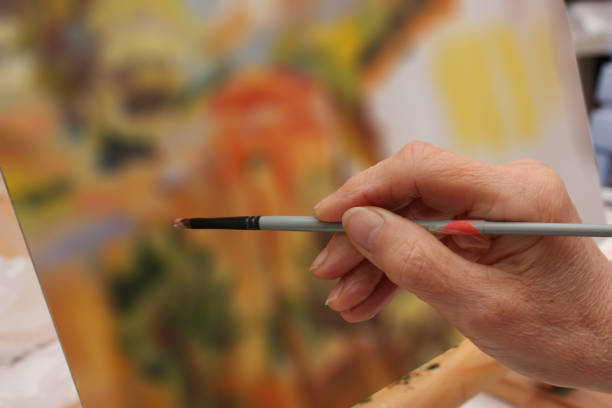 istock Painter painting a canvas  Art painting  Painting workshop 1355241798