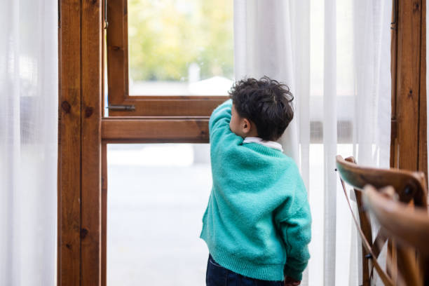 istock The little boy by the window 1355243496