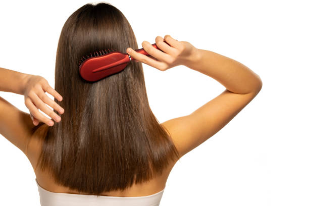 istock woman brushing her hair 1355244806