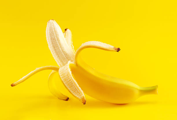 istock banana on a yellow background close-up shot in the studio 1355247259