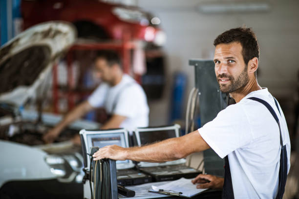 istock Young mechanic working in auto repair shop. 1355247589