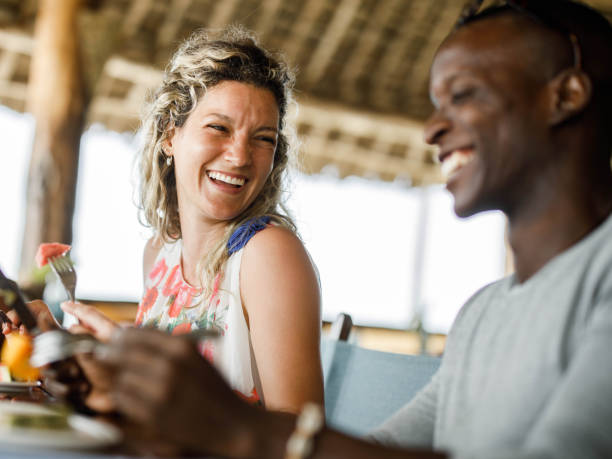istock Cheerful friends talking during their lunch at a restaurant. 1355248776