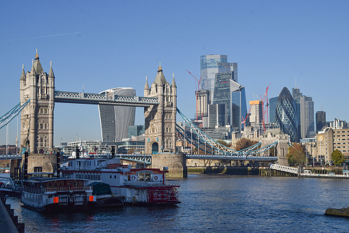 London, UK - November 23 2021: Tower Bridge and City of London with a clear blue sky.