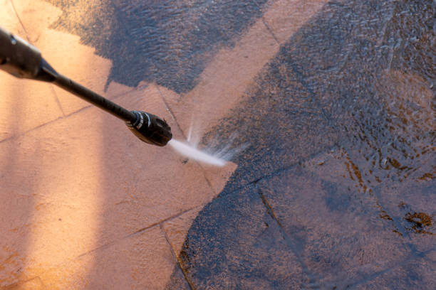 Cleaning dirty backyard paving tiles with pressure washer cleaner. Cleaning dirty backyard paving tiles with pressure washer cleaner. Spring clean up hanging stone stock pictures, royalty-free photos & images