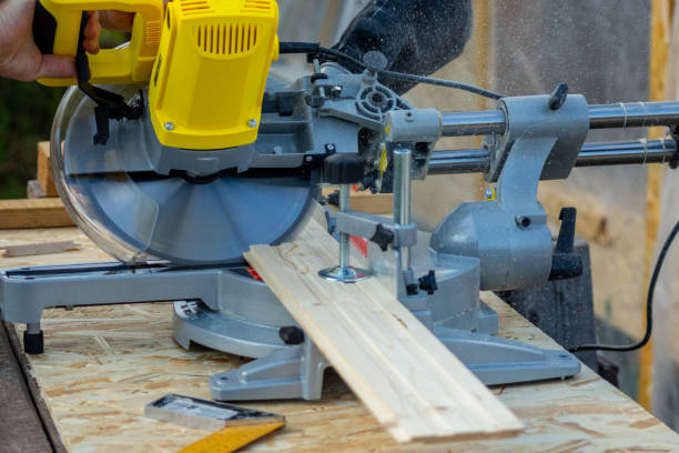 istock Sawing a board with a miter saw 1355250318