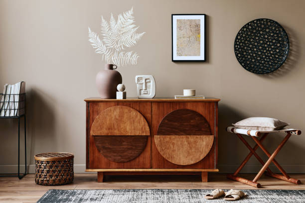 istock Stylish interior with design wooden commode, mock up poster frame and elegant personal accessories. Modern living room in classic house. 1355250642
