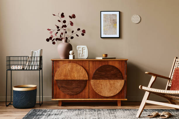 istock Stylish interior with design wooden commode, mock up poster frame and elegant personal accessories. Modern living room in classic house. 1355250645
