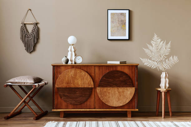 istock Stylish interior with design wooden commode, mock up poster frame and elegant personal accessories. Modern living room in classic house. 1355250698