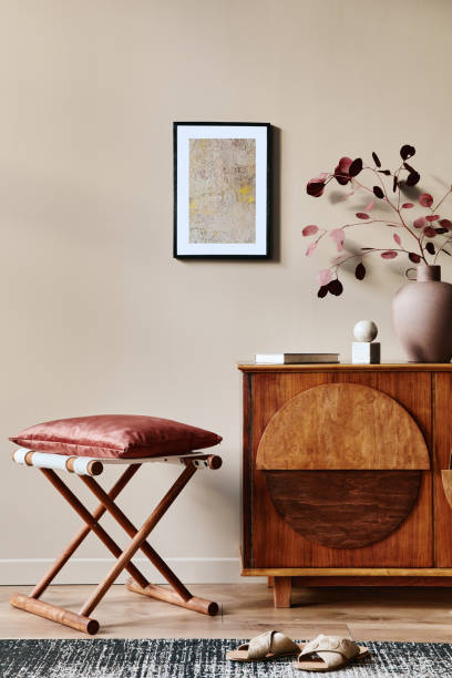 istock Stylish interior with design wooden commode, mock up poster frame and elegant personal accessories. Modern living room in classic house. 1355250705