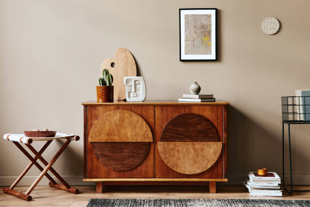 istock Stylish interior with design wooden commode, mock up poster frame and elegant personal accessories. Modern living room in classic house. 1355250712