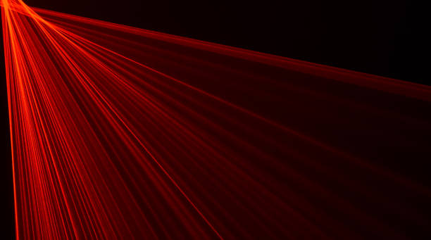 istock Abstract red lines drawn by light on a black background 1355250729