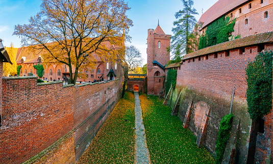 Malbork - courtyard of The Castle of the Teutonic Order in a sunny autumn day. Blue sky on the background.