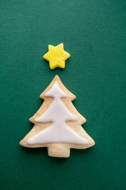 istock Christmas tree cookie with icing and star on green background 1355250891