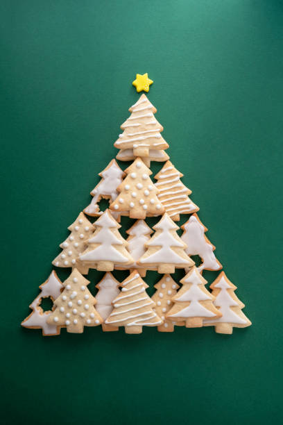 istock Festive composition Christmas tree made from christmas tree shaped cookies on green background 1355251008