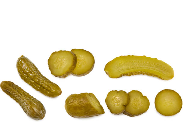 istock marinated pickled cucumbers with slices isolated on white background. Clipping path and full depth of field. Top view 1355254943