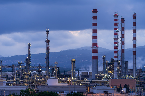 Tarragona, Spain - June 29, 2021: Panoramic view of the repsol refinery and its chimneys in Tarragona at sunset. Cataluña, Spain