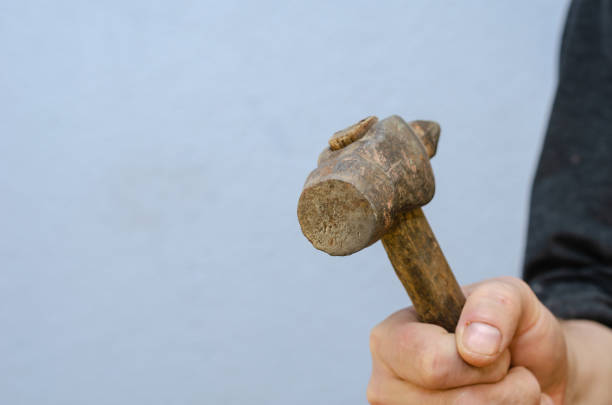istock Close-up of a man's hand holding a hand tool. 1355256524