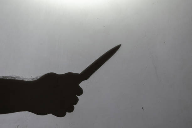 istock Blur, defocus, noise, grain effect. Dark silhouette of a man's h 1355256585