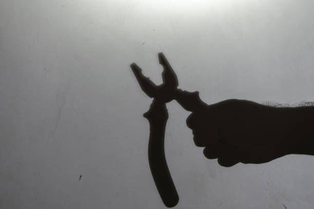 istock Blur, defocus, noise, grain effect. Dark silhouette of a hand ho 1355256587