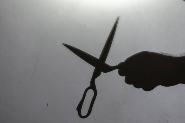 istock Blur, defocus, noise, grain effect. Dark silhouette of a man's h 1355256593