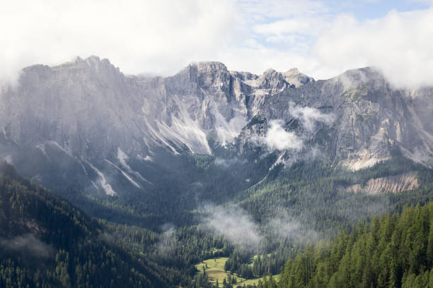 View of the Italian Dolomites mountain range with low clouds