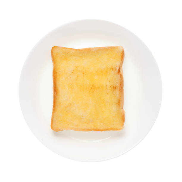 istock Slices toast bread in dish isolated on white background 1355259496
