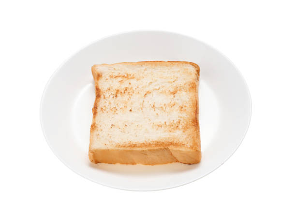 istock Slices toast bread in dish isolated on white background 1355259524