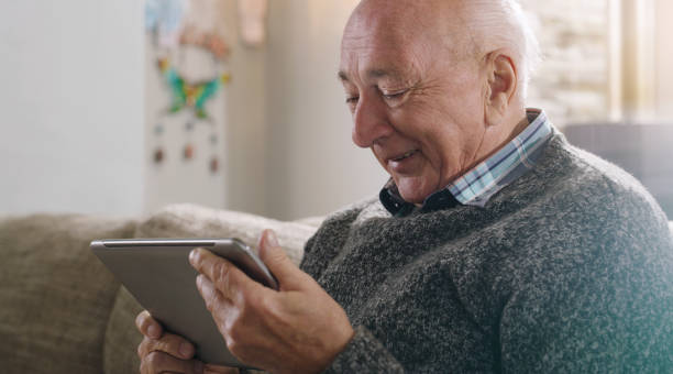 istock Shot of a senior man using a digital tablet at home 1355259763