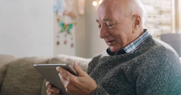 istock Shot of a senior man using a digital tablet at home 1355259768