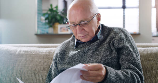 istock Shot of a senior man going through paperwork at home 1355259807
