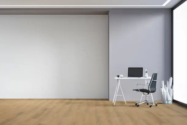 Home office -workdesk with computer, equipment and decoration on hardwood floor in front of empty partly gray, partly white wall with copy space. 3D rendered image.