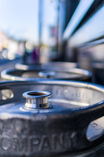 A shallow depth of field image of the polished nozzle of the used beer keg with the outer sections battered from transportation and use.