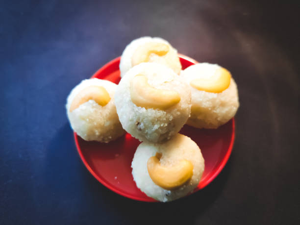 rava laddu sweet rava laddu by preparation of roasted rava with sugar,milk,cardamom, golden roasted cashew nuts on the top of laddu which is famous and treditional sweed in south india. rawa island stock pictures, royalty-free photos & images