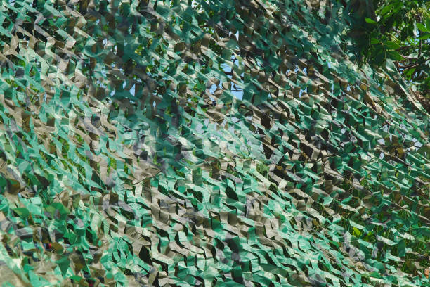 istock Military green camouflage net masking and covering secret object 1355261299
