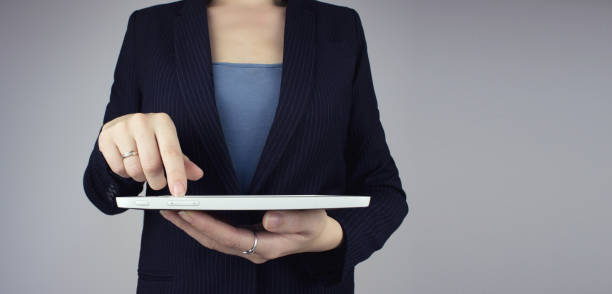 istock Automation Software Technology Process System Business concept. White tablet in businesswoman hand with digital hologram icon sign on grey background. 1355262219