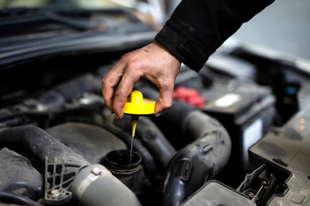 check the oil in car engine - motor oil bottle imagens e fotografias de stock