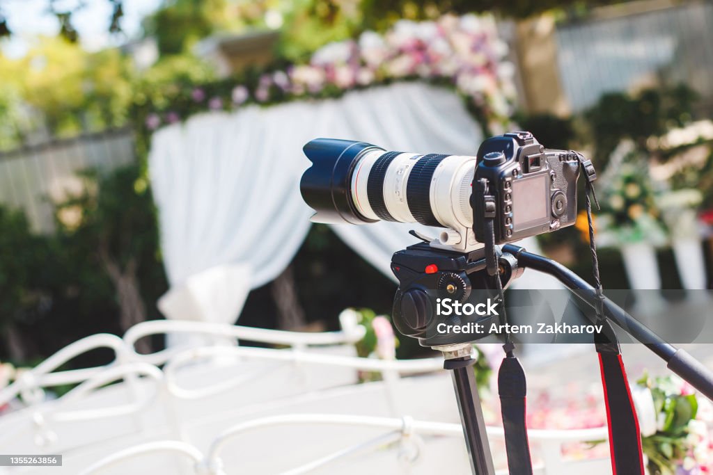The work of photographer and videographer at the wedding. The camera and lens. Wedding Stock Photo