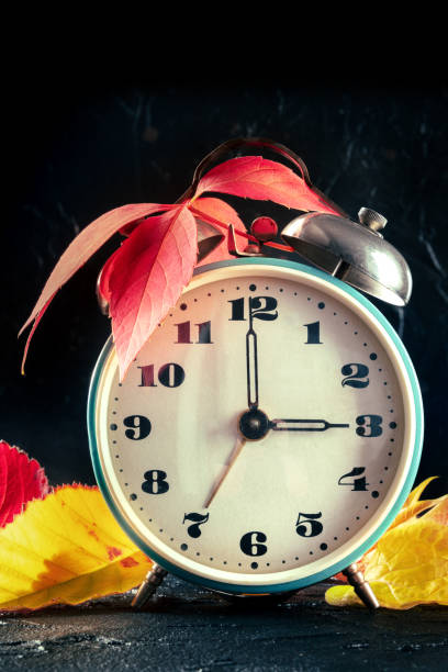 istock Daylight Savings Time concept, fall back in autumn. A retro alarm clock 1355263914
