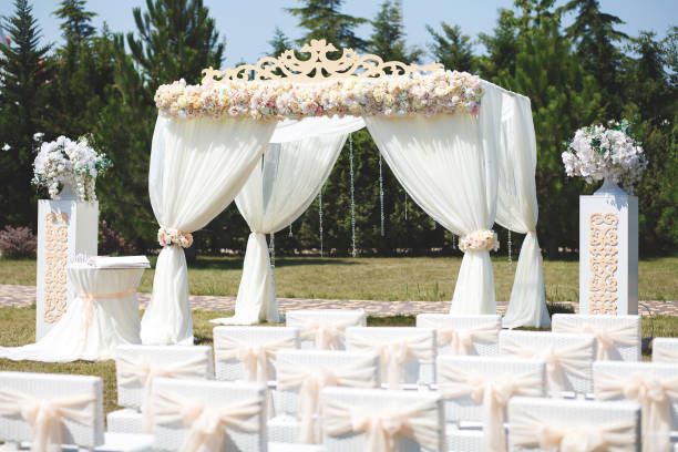 istock White wedding tent for the ceremony outdoors. Arch. Chairs. 1355263952