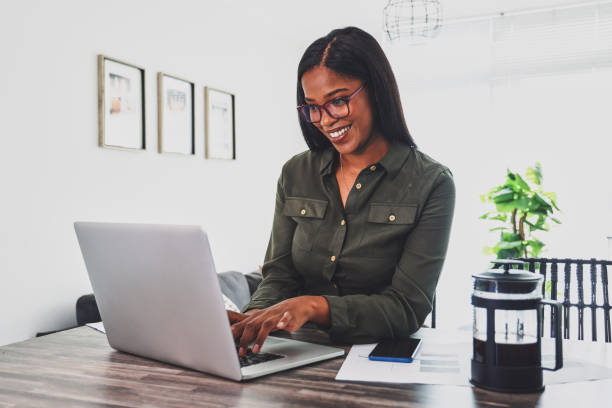 istock Shot of a young woman using her laptop while working from home 1355265487