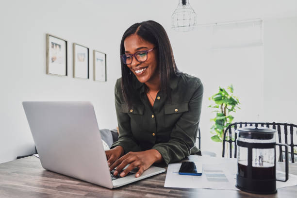 istock Shot of a young woman using her laptop while working from home 1355265499
